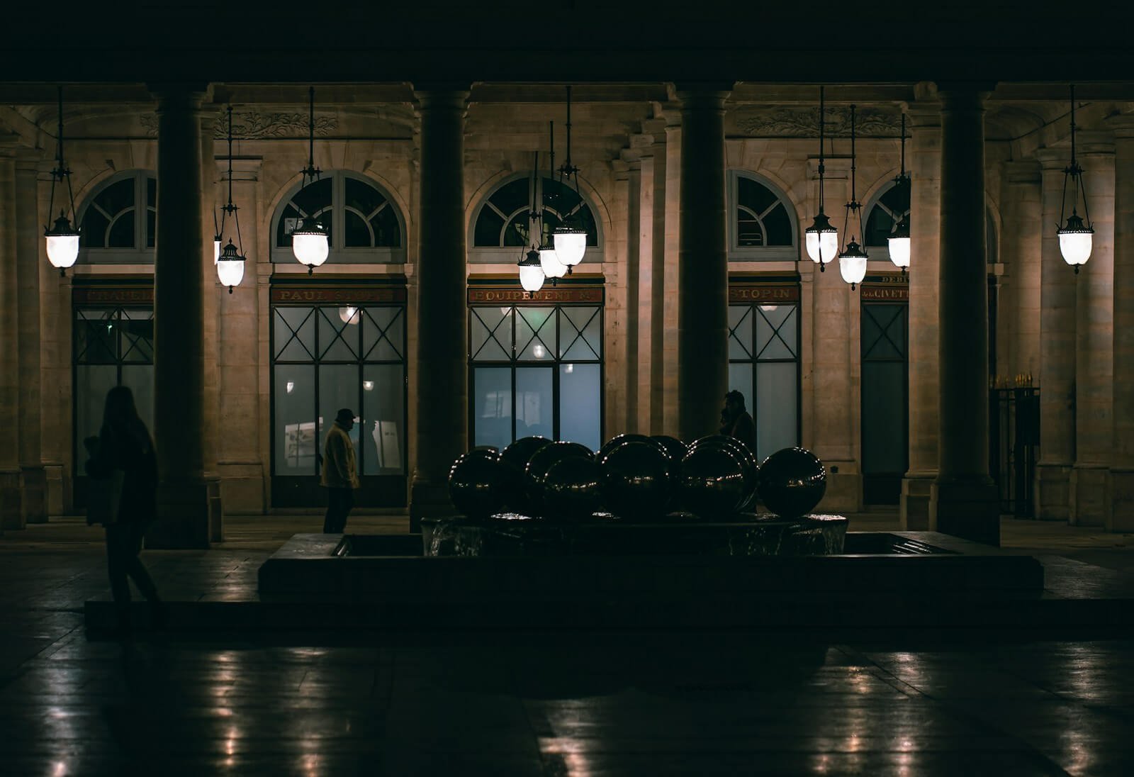 a group of people standing in a large room with a large group of chairs