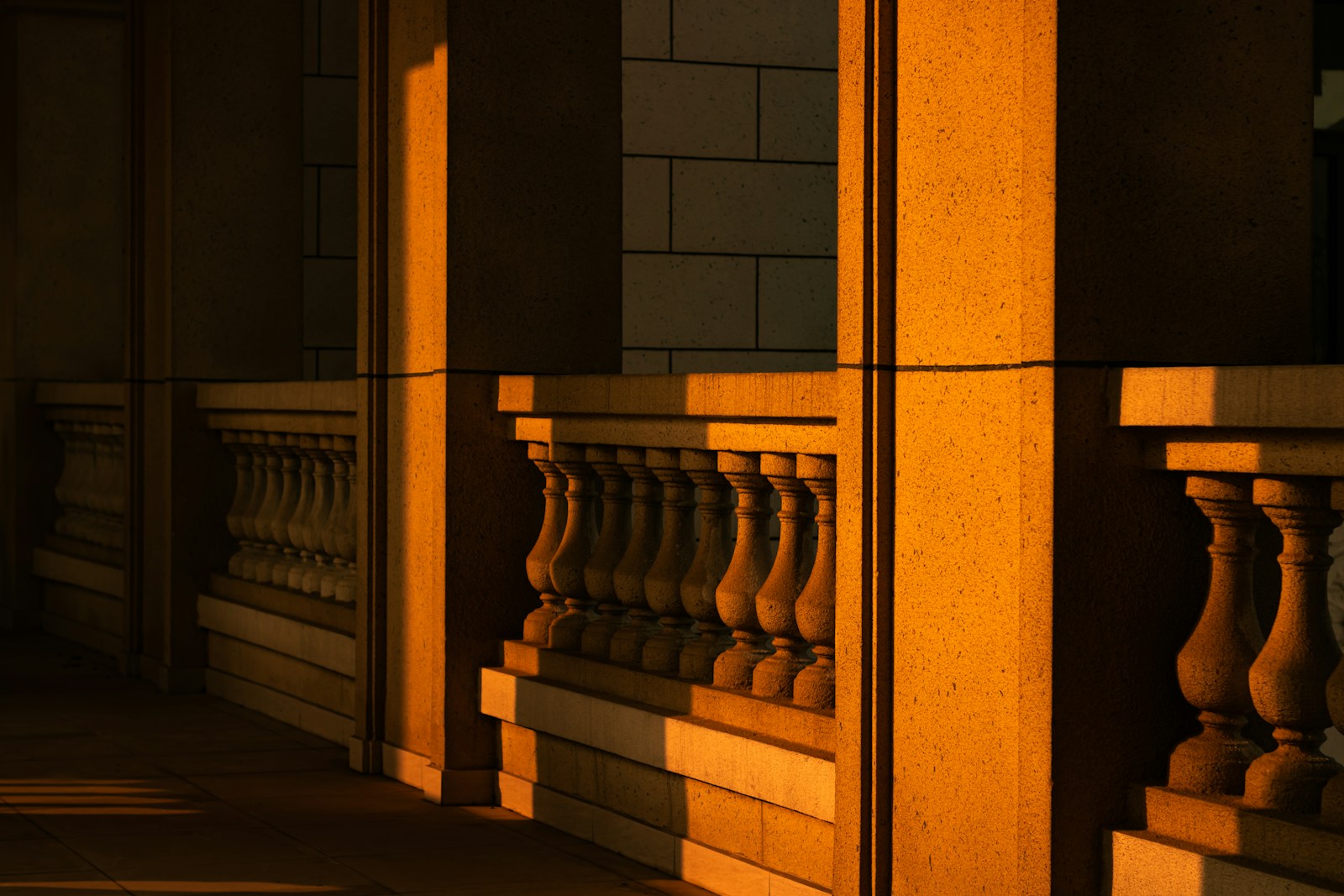 Stone balustrade illuminated by warm sunset light.